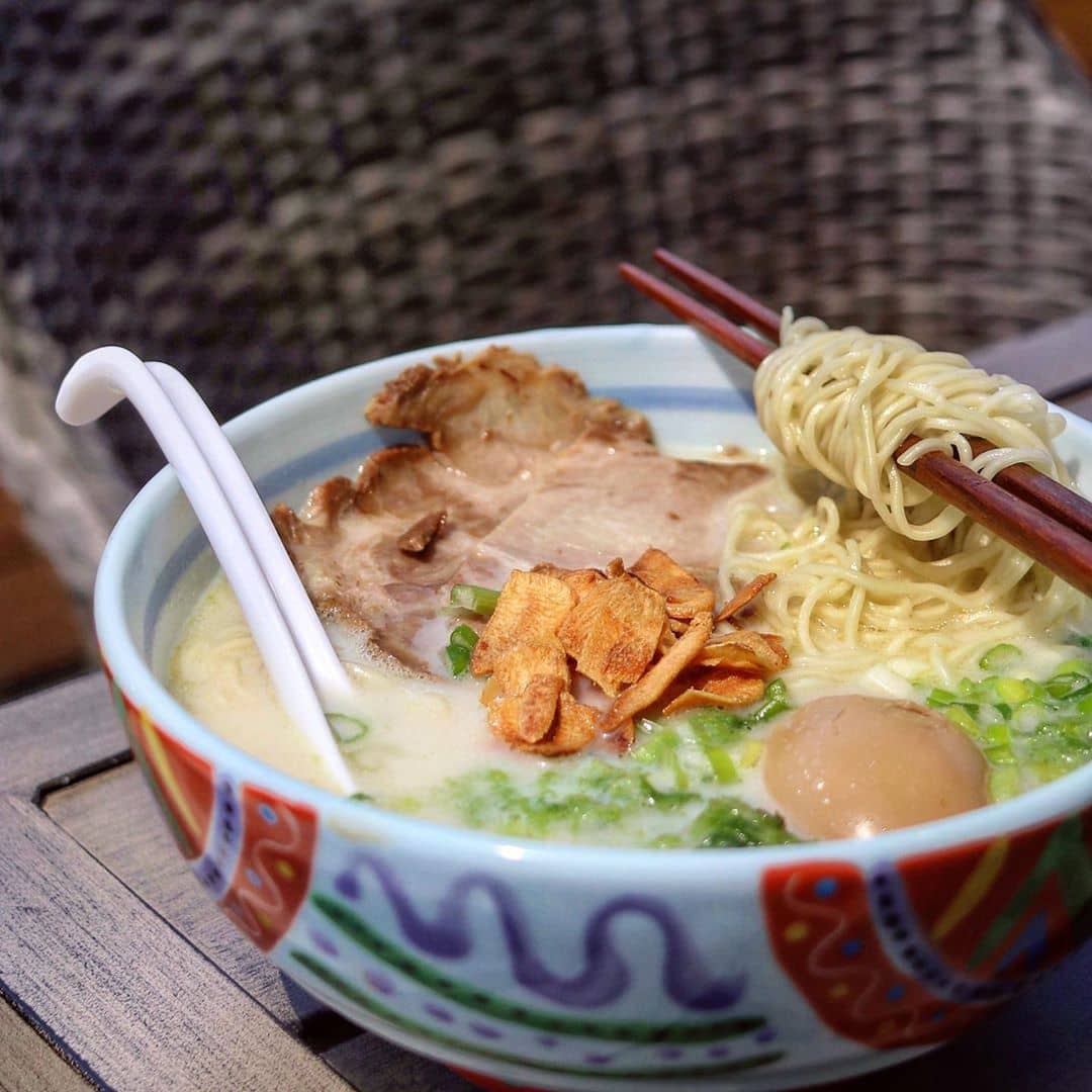 ramen bowl with noodles, egg, garlic chips, and cha siu