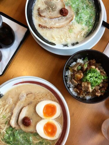 ramen bowls with eggs, broth, chasiu and side dish