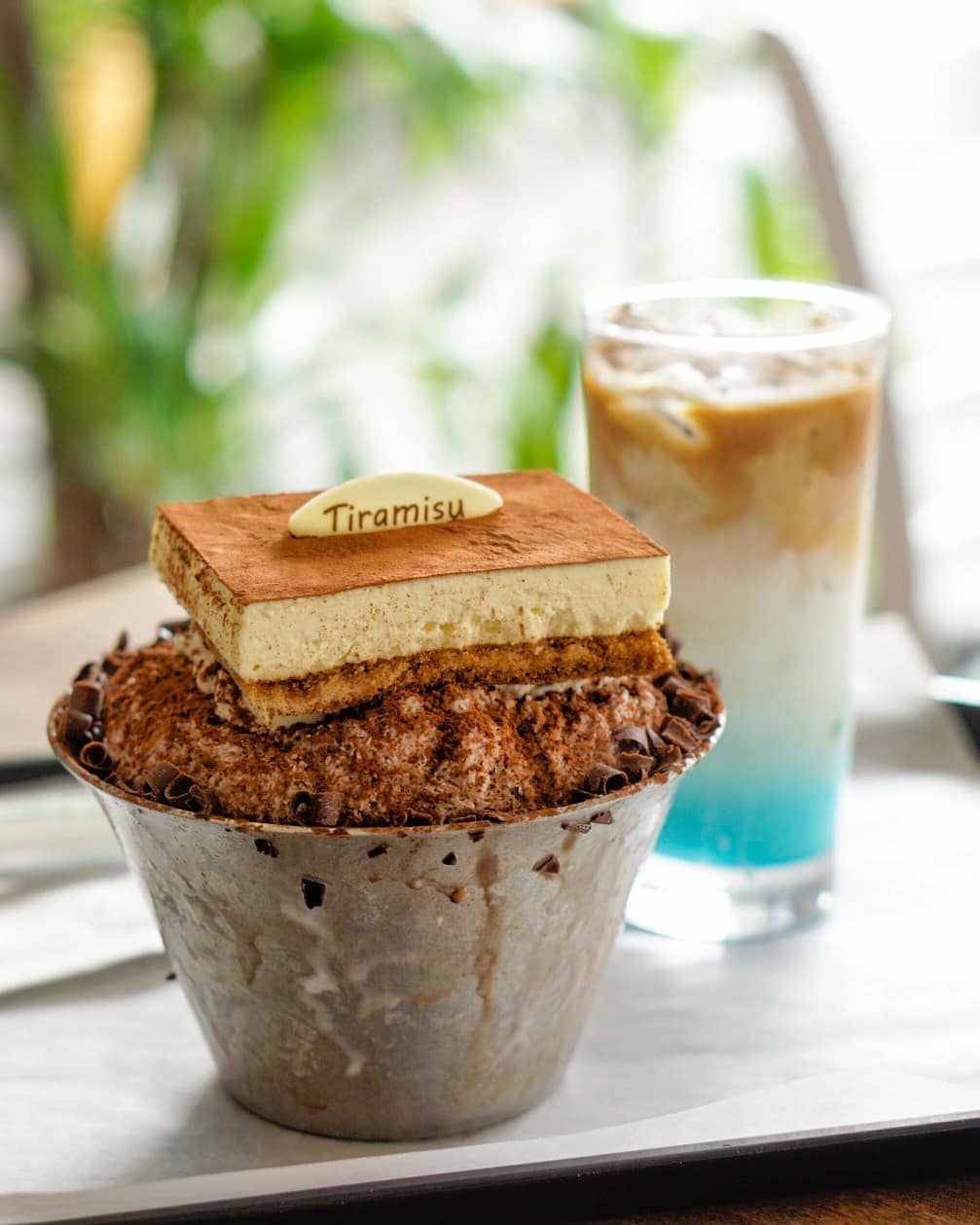 korean shaved ice tiramisu flavoured with drink in the background