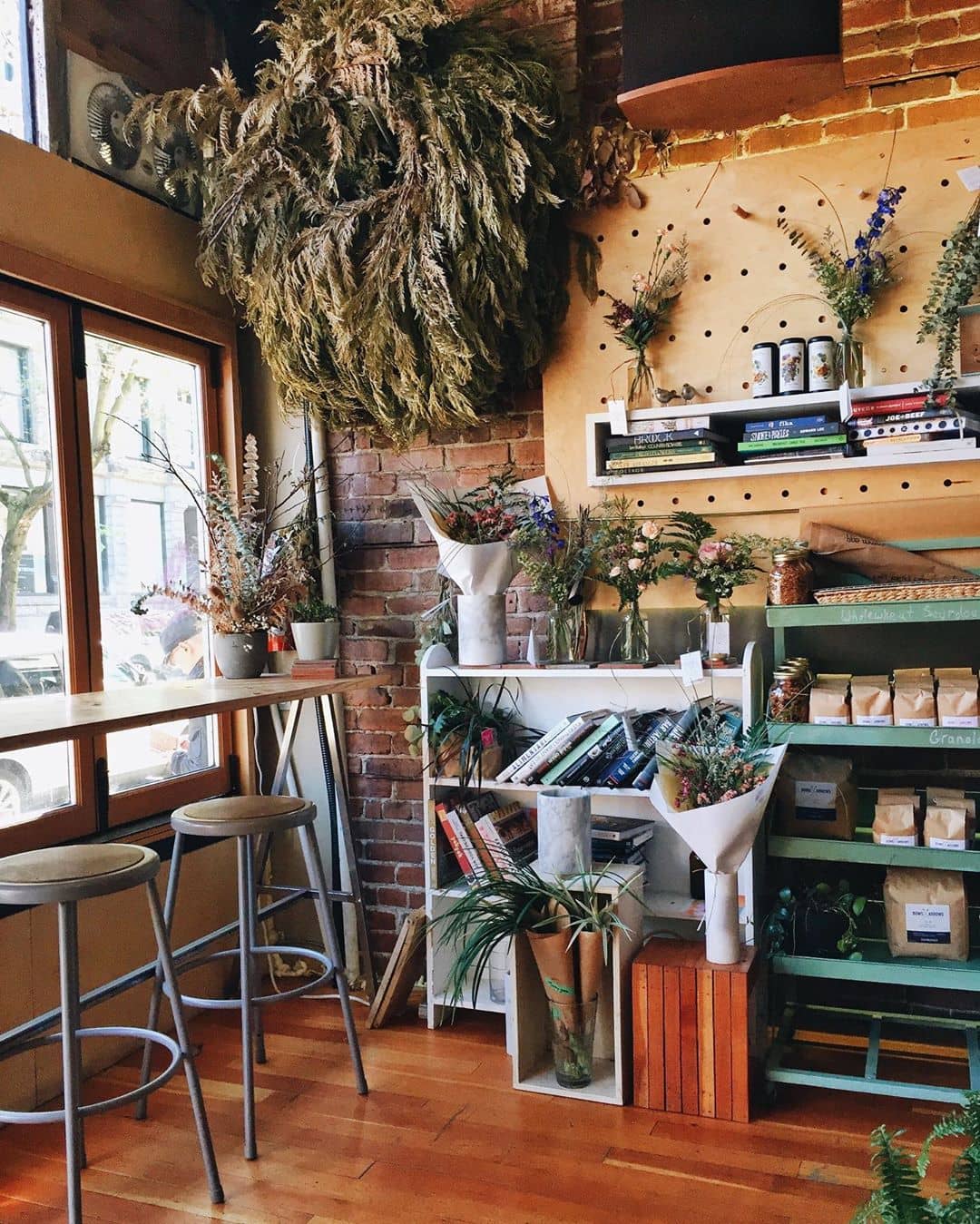 Coffee shop corner with flowers and counter with stools