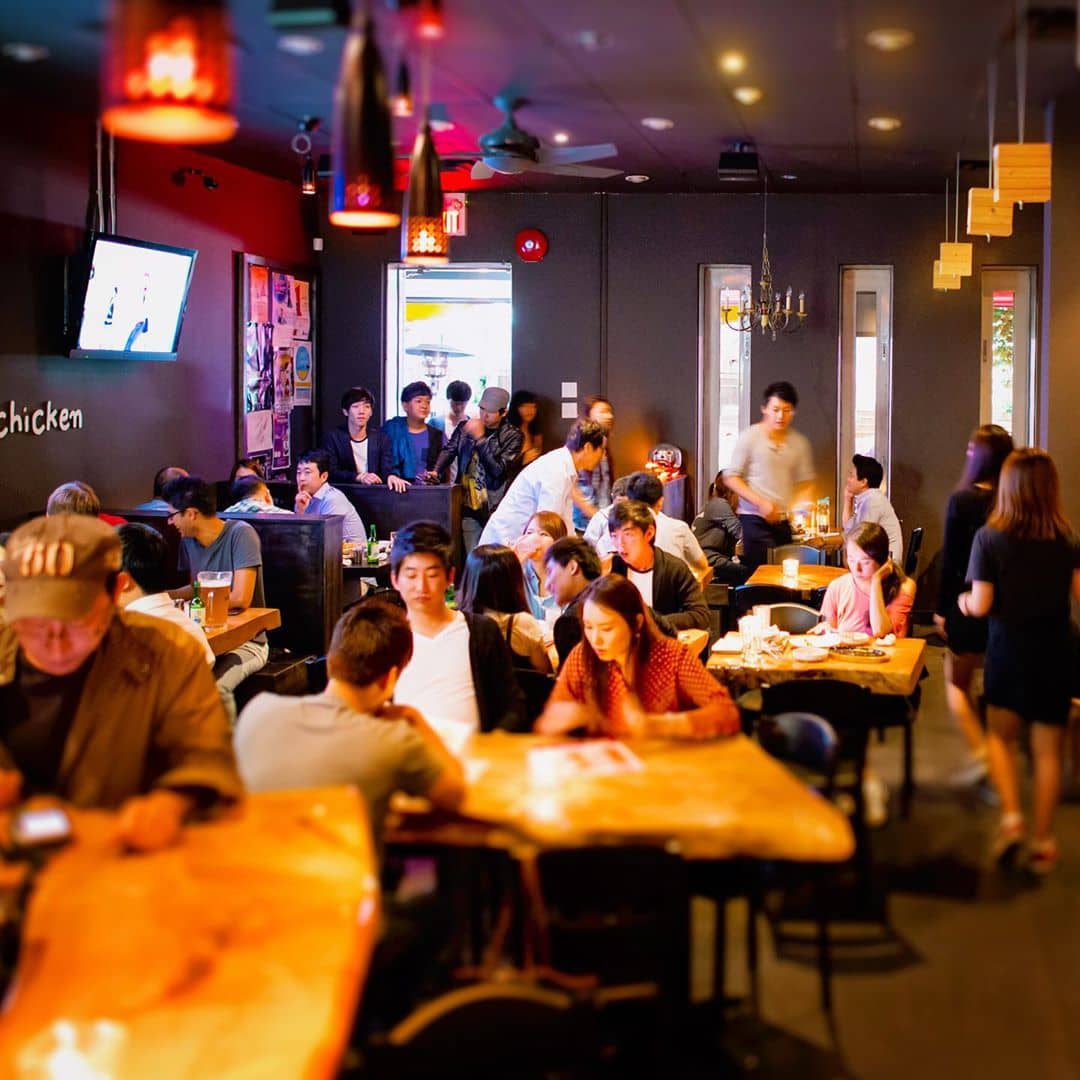 dimly lit restaurant with people sitting inside