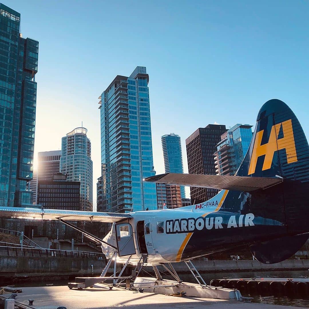 Vancouver to Victoria harbour air seaplane on water by highrises