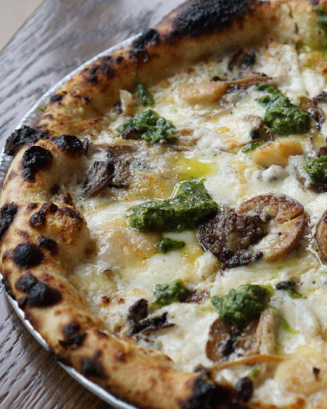 mushroom pizza on wooden table