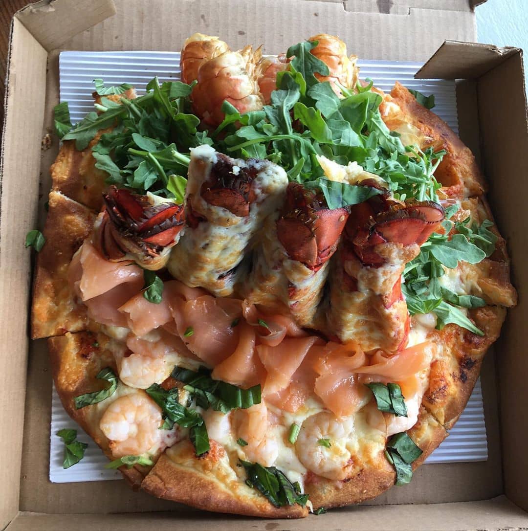 Serpent pizza with lobster tails smoked salmon and shrimp