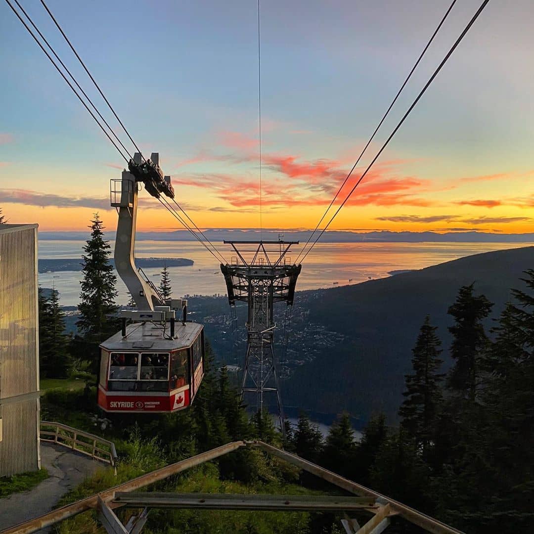 Grouse Mountain Guide - gondola lift arriving at top of mountain during sunset
