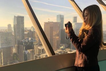 most scenic viewpoints vancouver - vancouver lookout with girl taking photos out of window