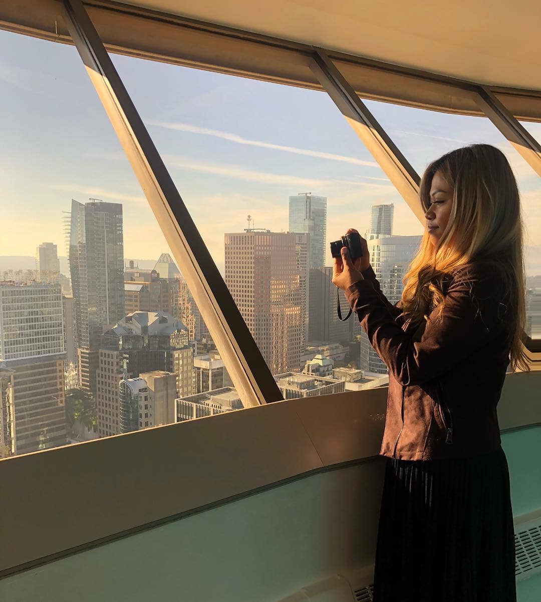 most scenic viewpoints vancouver - vancouver lookout with girl taking photos out of window