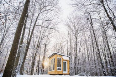 coolest airbnb canada - the cabin at fernwood hills exterior in forest during winter