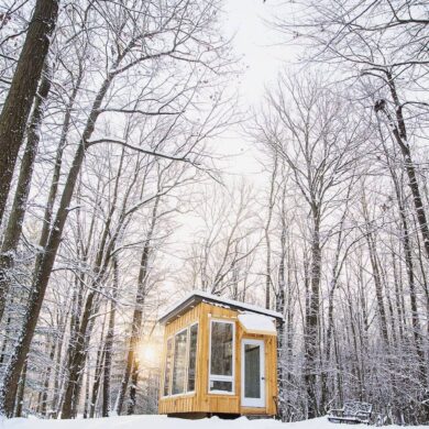 coolest airbnb canada - the cabin at fernwood hills exterior in forest during winter