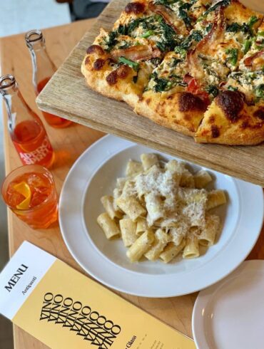 best italian restaurants in vancouver - di beppe pizza and pasta and spritz on table