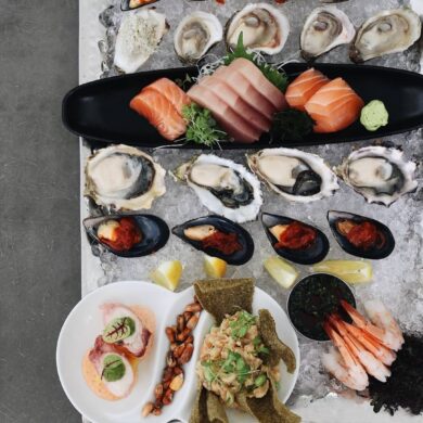 best seafood in vancouver - ancora waterfront dining with sushi and assorted seafood on ice