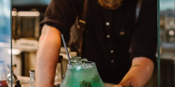 10 Best Cocktail Bars In Vancouver - botanist dining cocktail of deep cove with bartender handing drink