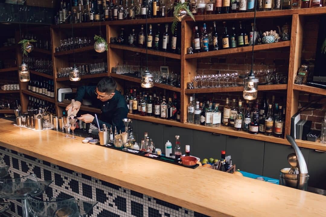 10 Best Cocktail Bars In Vancouver - l'abattoir cocktail bar with bartender making drink