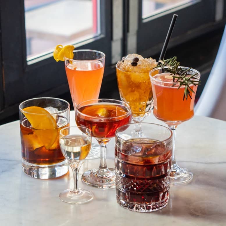 10 Best Cocktail Bars In Vancouver - uva wine bar negroni drinks on table