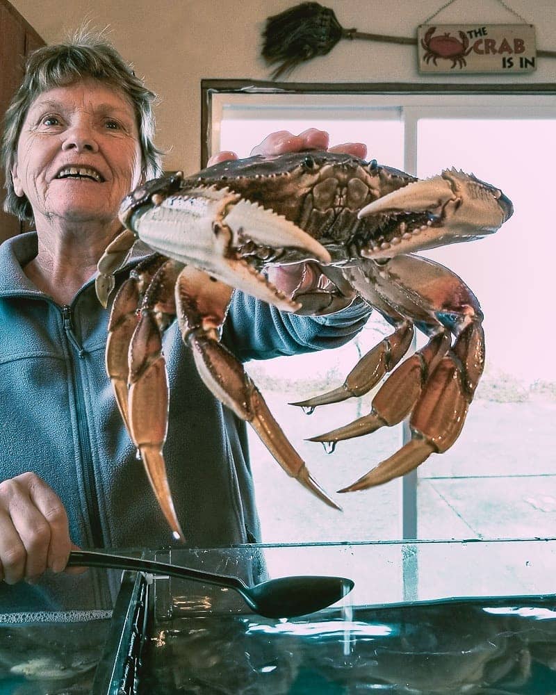 Places to Eat and Drink in Tofino - the crab lady holding crab