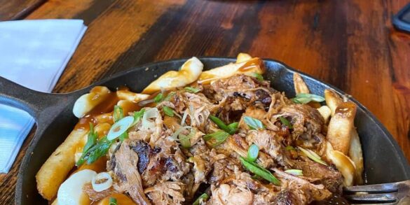 best squamish restaurants - copper coil still poutine in skillet on table