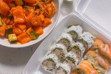 roll of sushi in take out box and spicy salmon sashimi in bowl on the side - best coquitlam sushi - sushi california