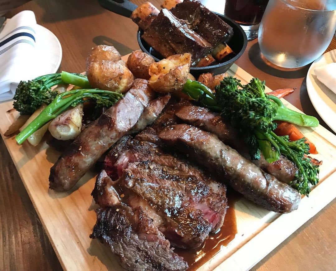 bison meat and veggies on a wooden platter - best banff restaurants - the bison restaurant
